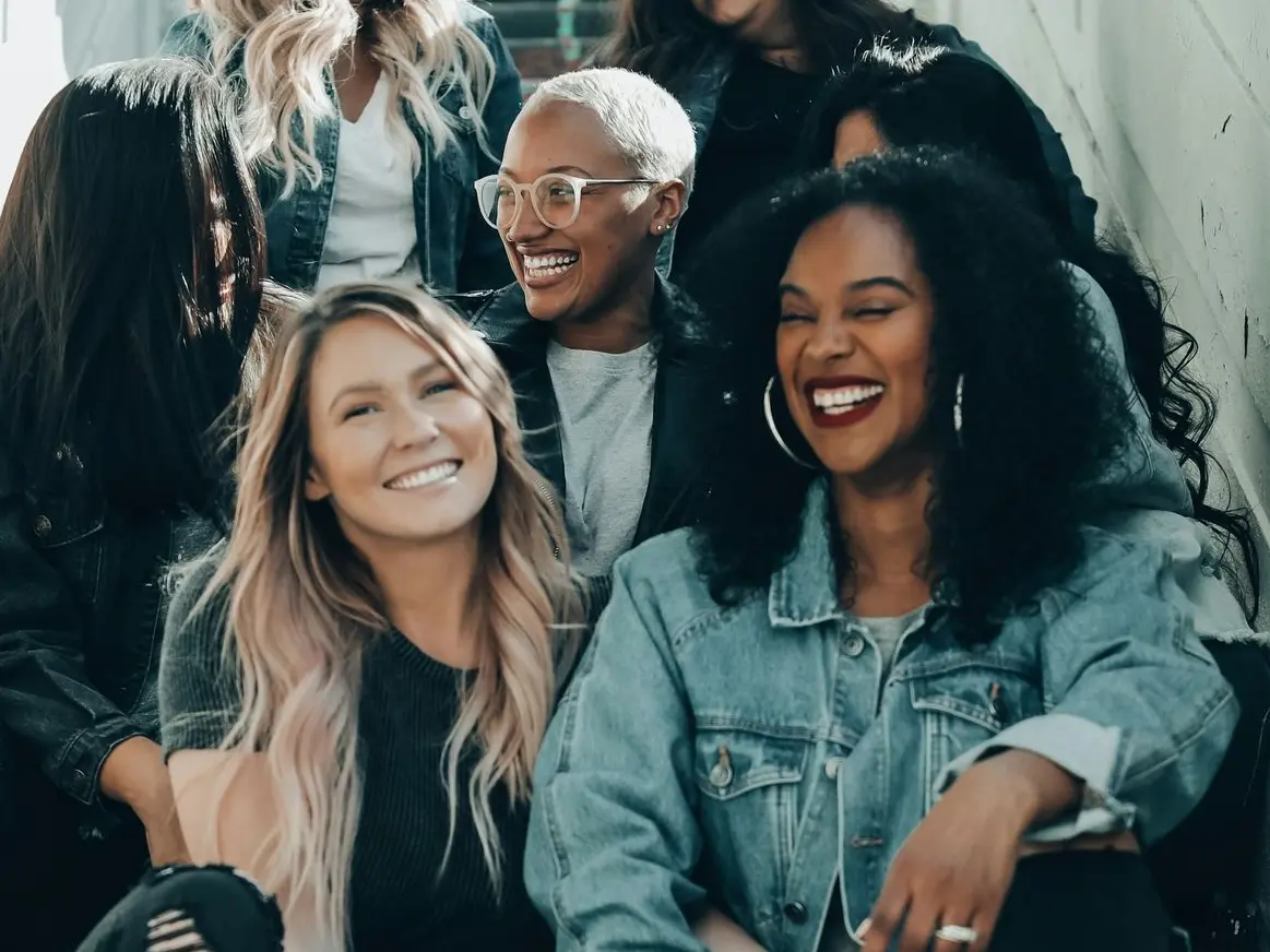 3 women sitting on red carpet